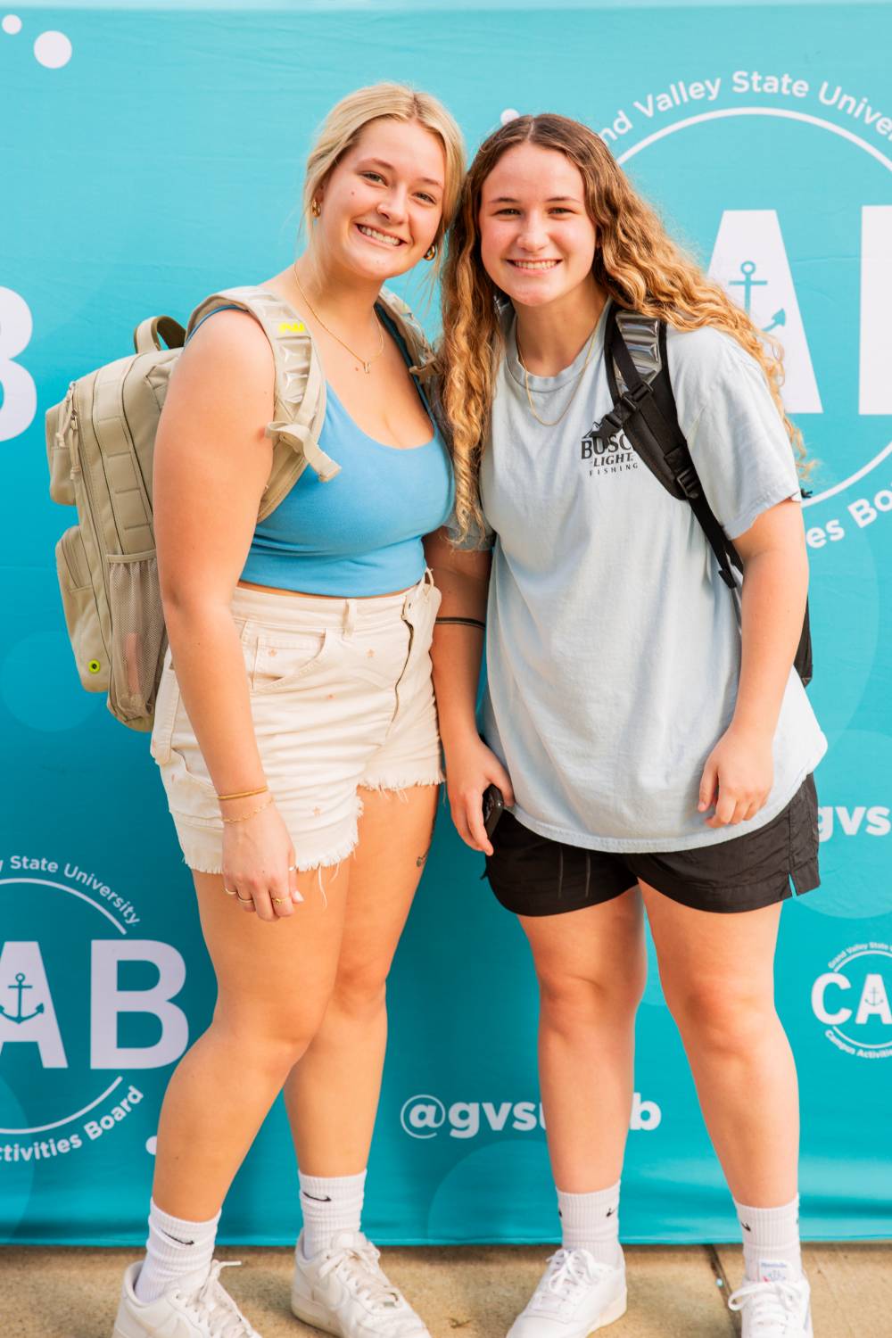 two students posing in front of CAB backdrop at Laker Kickoff photo booth